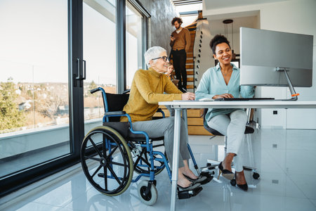 A bright, contemporary office space with a diverse group of professionals working togetherの写真素材