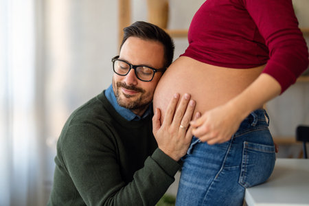 Man in love hugs his pregnant wife, they are waiting together for the babys arrival. Love, familyの写真素材