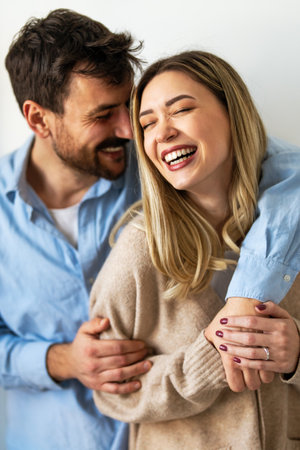 Happy multiethnic couple, love and hug laughing in joyful happiness for bonding time togetherの写真素材