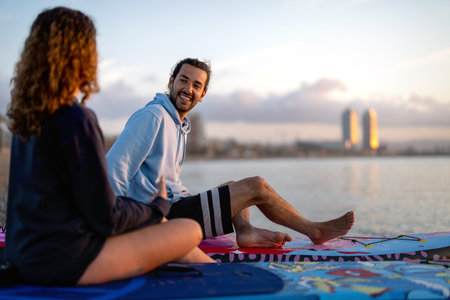 People paddle boarding together on calm water at sunset create a peaceful lifestyle outdoor