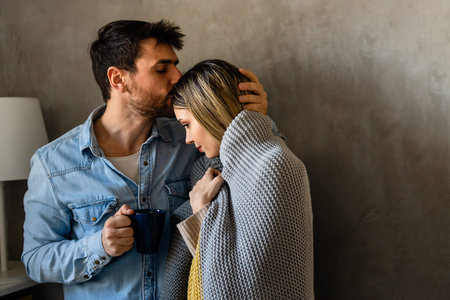 A couple supports each other through viral illness, fatigue and the discomfort of a sick day at home