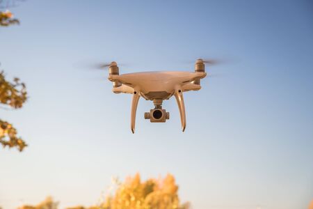 Demonstration flight drone DJI Phantom 4 Pro in the autumn forest. Moscow, Russia. October 12, 2018