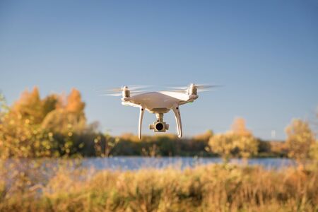 Demonstration flight drone DJI Phantom 4 Pro in the autumn forest. Moscow, Russia. October 12, 2018