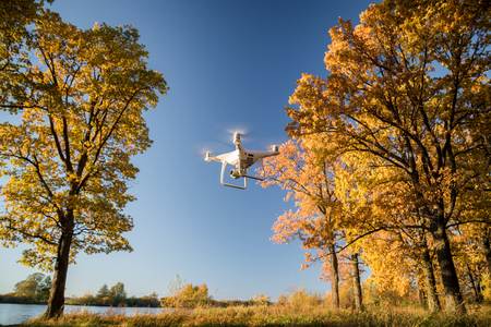 Demonstration flight drone DJI Phantom 4 Pro in the autumn forest. Moscow, Russia. October 12, 2018のeditorial素材