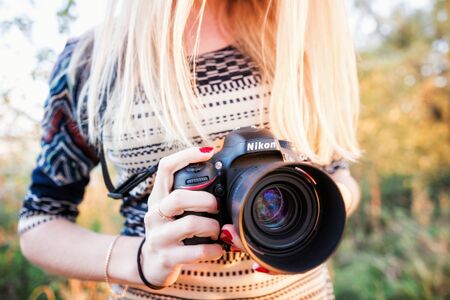 Moscow, Russia - October 4, 2014: Nikon D610 camera photographer holds the camera and Nikkor 50mm f / 1.4G lensのeditorial素材