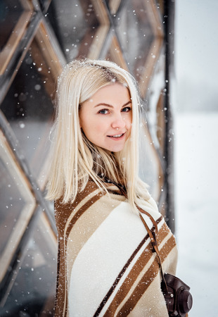 Beautiful blonde girl with a vintage landscape. Nikola-Lenivets, Russia