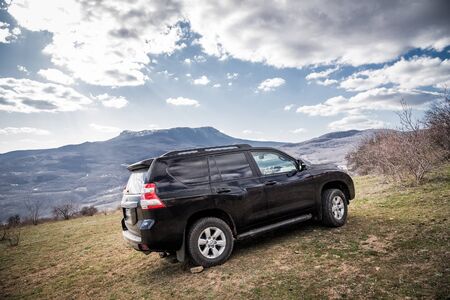 Alushta, Republic of Crimea - March 23, 2019: Black off-road car Toyota Land Cruiser Prado parked in natureのeditorial素材
