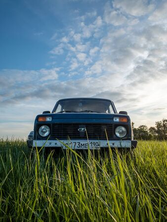 Moscow, Russia - May 24, 2019:  Blue Russian off-road car Lada Niva 4x4 (VAZ 2121 / 21214) parked on the field.のeditorial素材