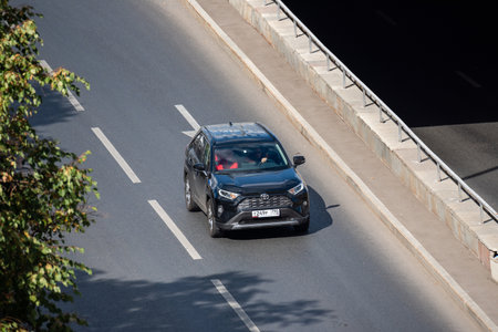 Moscow, Russia - September 27, 2022: A black Japanese car Toyota RAV4 XA50 is driving down the road...