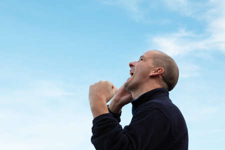 A man on a mobile phone, happy to receive some newsの写真素材