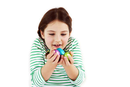 A little girl looking at her easter eggs with excitementの写真素材