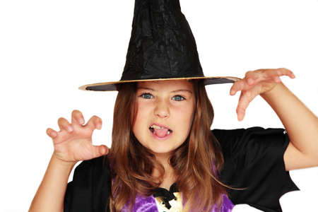 A girl in a witch's costume making a scary faceの写真素材