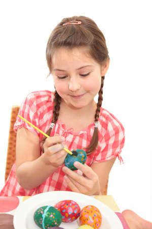 A girl painting an Easter eggの写真素材