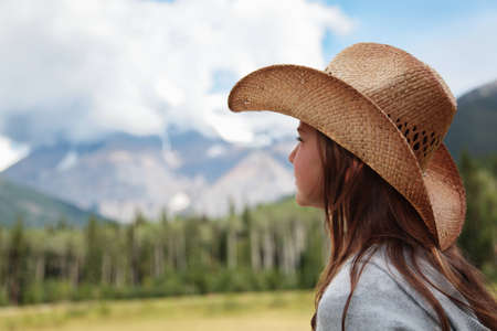 A cowgirl looking towards Mount Robson in the Canadian Rockiesの写真素材