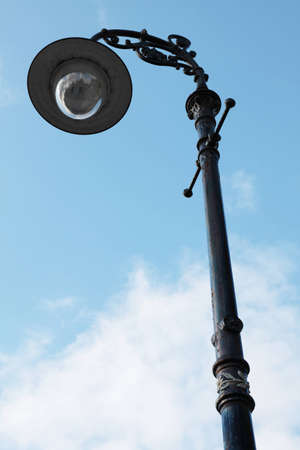 An old iron street lamp (in Royal Bath) against a blue skyの写真素材