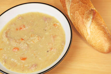 Ham and lentil soup with a baguette.の写真素材