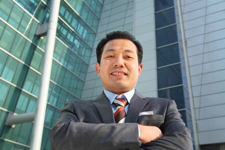 businessman front office modern building smilingの写真素材