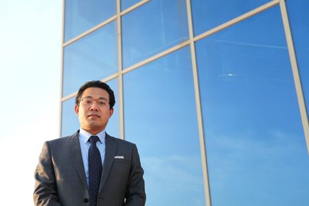 young executive standing front office looking on cameraの写真素材