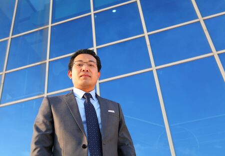 young busineesman standing front office look on you cameraの写真素材