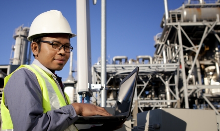 engineer power and energy using laptop on location siteの写真素材