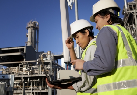 two engineer power and energy discussion on location site using laptop two engineer power and energy discussion on location site using laptop