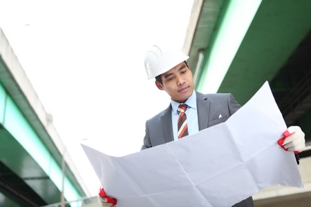 architect cheking a drawing  on highway construction siteの写真素材