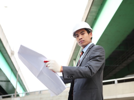 architect  with blueprint on highway construction siteの写真素材