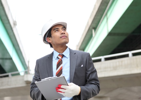Young architect working on location on a construction site の写真素材