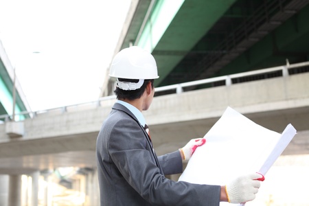 Young architect working on location on a construction siteの写真素材