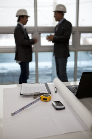 architects sitting at table and discussing a project in the officeの写真素材