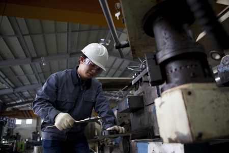 mechanical technician measuring detail after cncの写真素材
