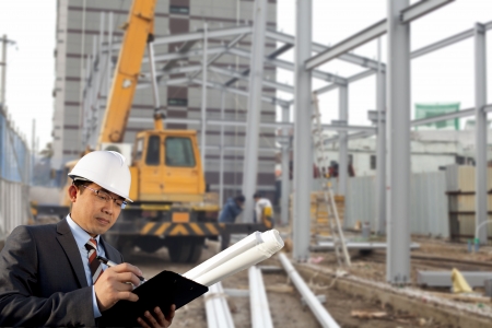 young architect standing front of construction siteの写真素材