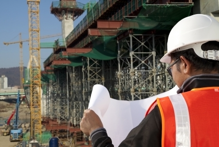builder inspector checking plan a construction site の写真素材