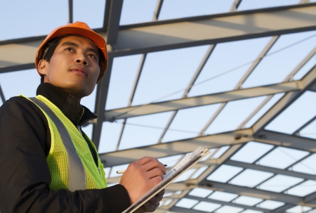 Engineer construction under new building checking plan, horizontal imageの写真素材