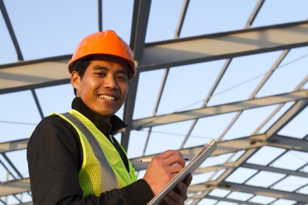 Engineer construction under new building checking plan, horizontal imageの写真素材