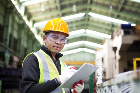 Factory worker with clipboard on the handの写真素材