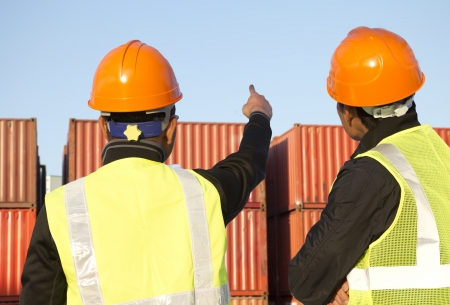 Two workers inspection on  stack of containersの写真素材