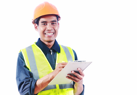 Asian man engineer writing on the board smile looking you camera isolated on white backgroundの写真素材