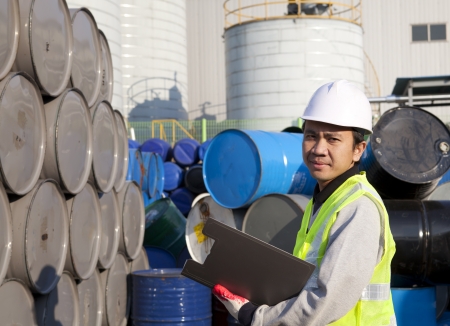 Portrait of a smiling confident supervisor stock  drum checking in warehouse の写真素材