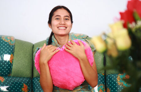 Young woman holding pink heart symbol, happy valentine dayの写真素材