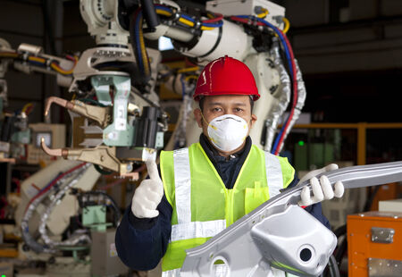 Industrial engineer holding metal production with giving thumb up
