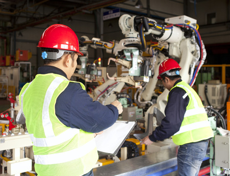 Factory workers team on working