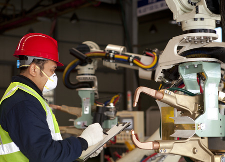 Technician checking robot machineの写真素材