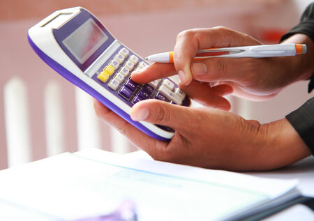 Woman hand with pen and calculator accounting financial reportの写真素材