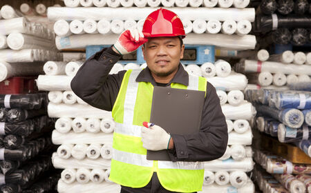 Textile factory labor standing  in werehouse fabricsの写真素材