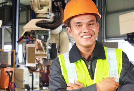 Man factory engineer or worker with robot machine inside modern industrial manufacturing, automobile industryの写真素材