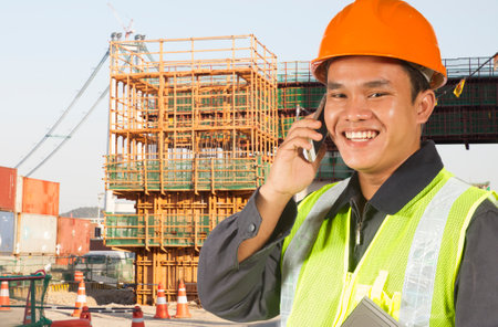 Construction worker talking with handphone on location siteの写真素材
