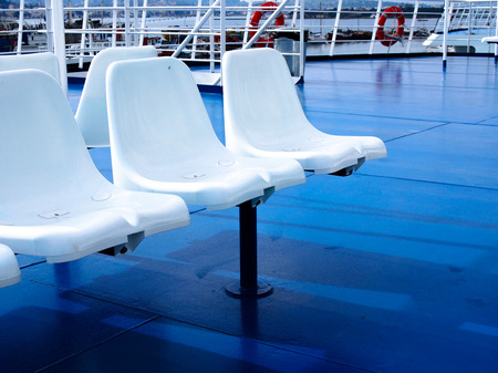Wite Plasic chairs on Blue colour Ferry boat.の写真素材