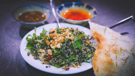 Street Food - Hen xuc banh trang (minced clams) is a combination of clams and crispy rice paper in Hoi An - Vietnamの写真素材