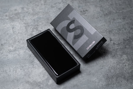 New Samsung Galaxy S21 smartphone on gray background.のeditorial素材